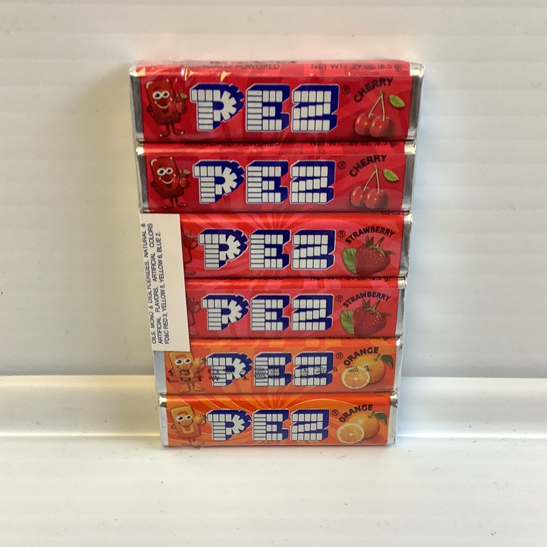Stack of colorful Pez candy refill boxes featuring cherry, strawberry, and orange flavors for Nassau Candy 19556