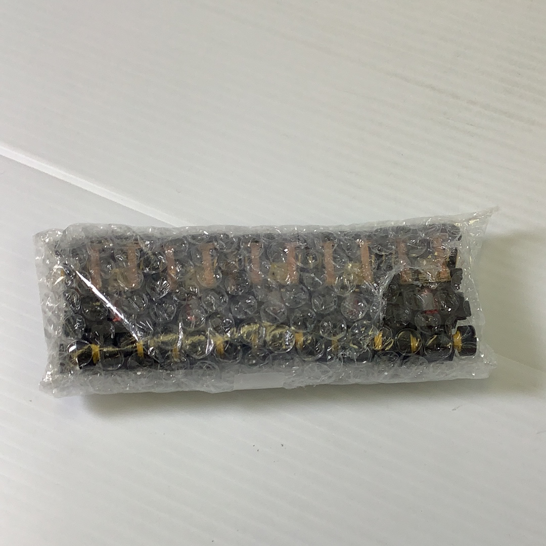 Assortment of black and gold electrical components in clear packaging for Tyco TCR TCR1501