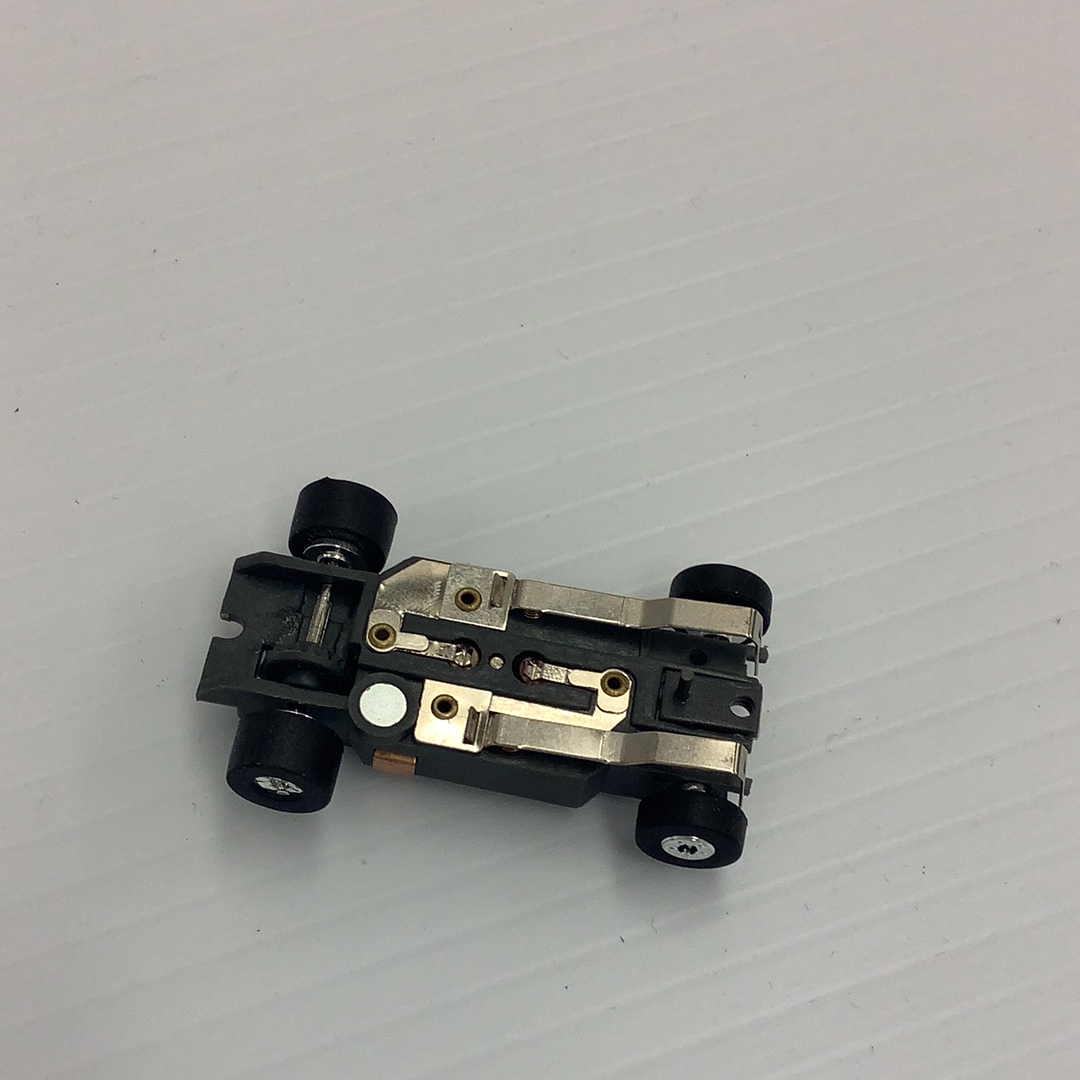 Slot car chassis with black wheels and silver metal components for Auto World PSCTJ-029, front view