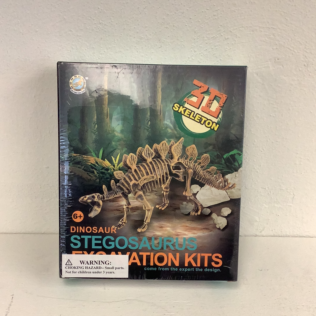 Dinosaur skeleton excavation kit showing a Stegosaurus skeleton in a jungle setting for IMEX Model Company IMX49018