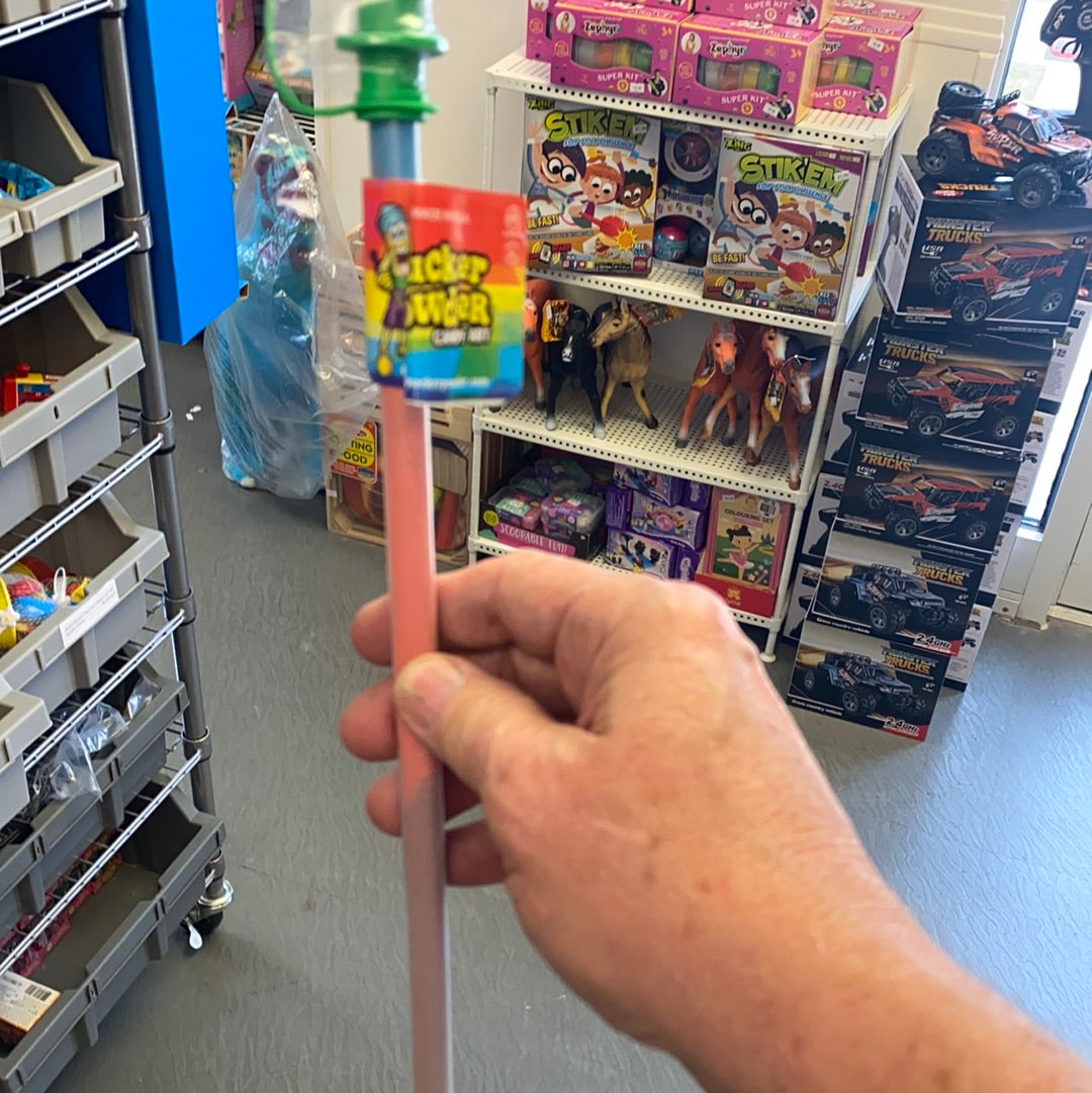 Hand holding a pink candy tube with a colorful wrapper visible for Creative Concepts CPPFTASM