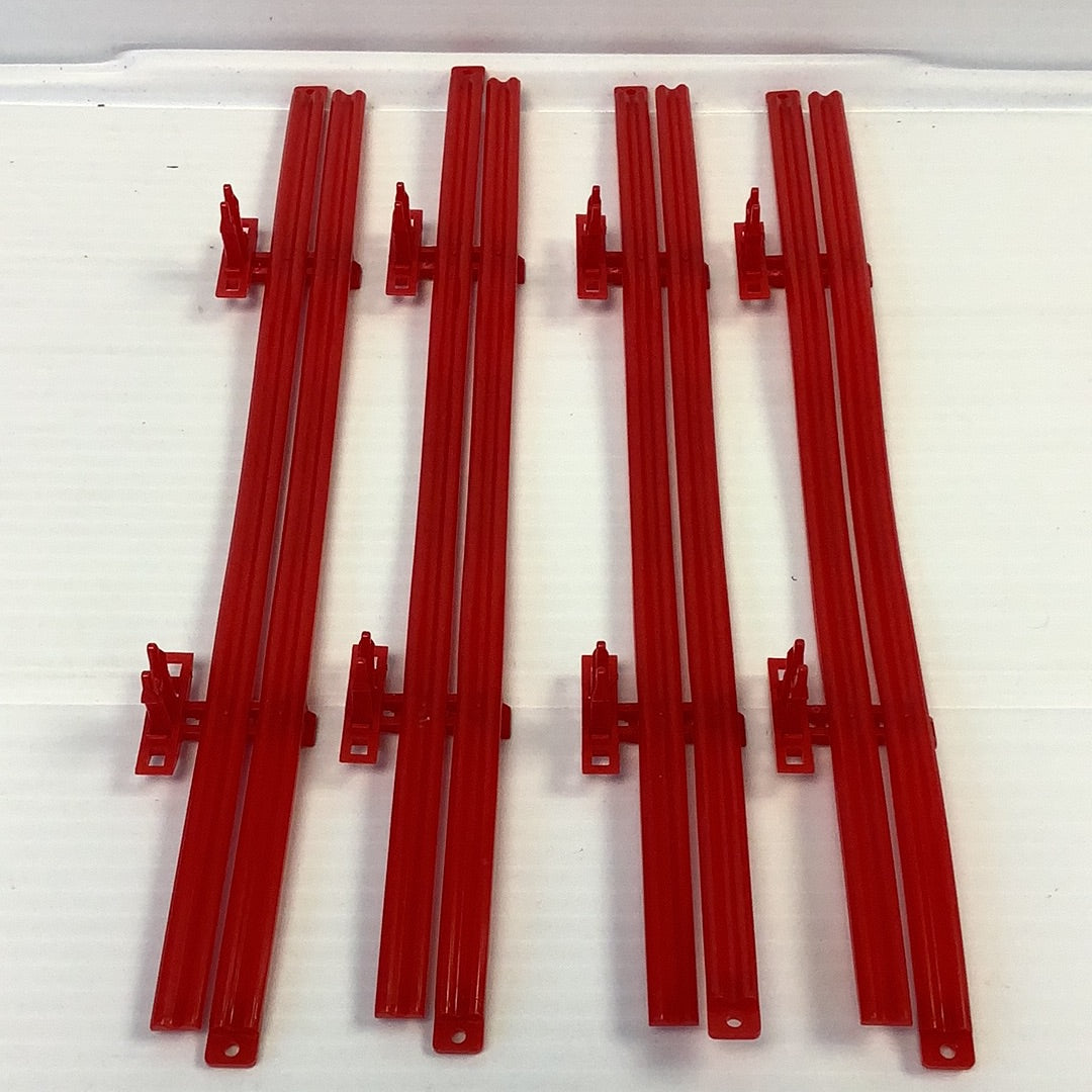 Four red guard rails for model train track, laid out horizontally for SCX 4RGR