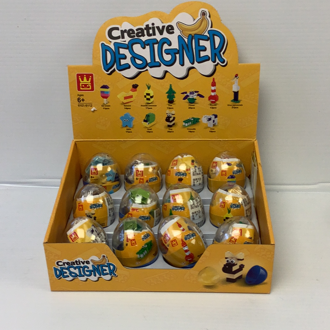 Assortment of decorated, uncolored craft eggs in a yellow box for IMEX Model Company WAG61016