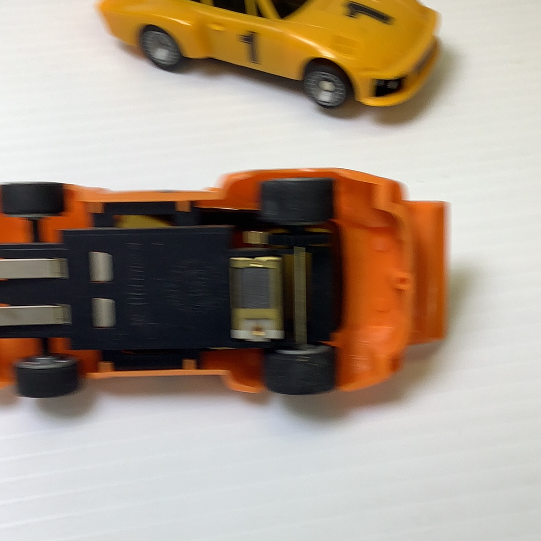 Yellow Porsche model car with visible Supertrax chassis components for Bachmann BAC0002