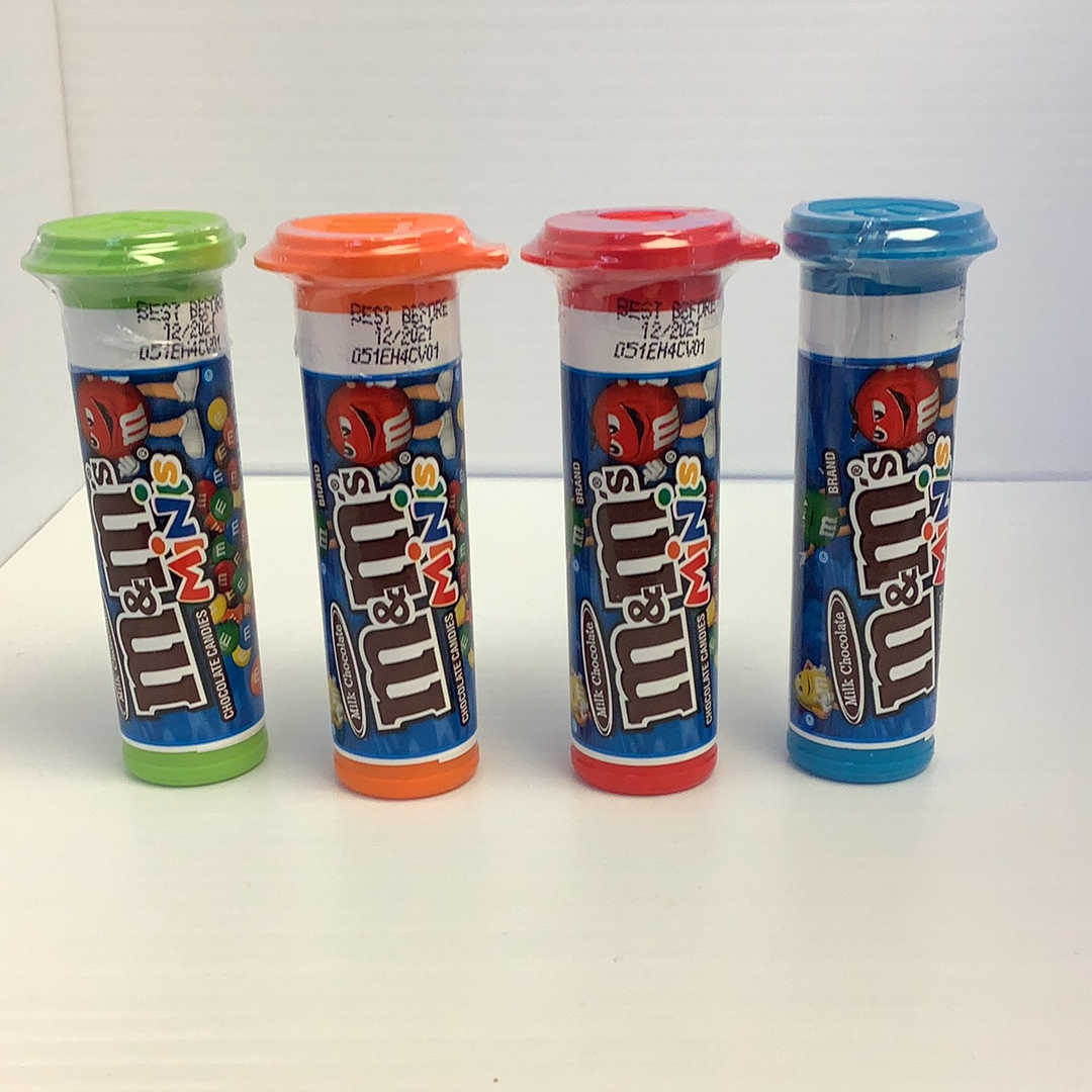 Four colorful, cylindrical candy containers lined up on a white surface for TOPPS 1411917