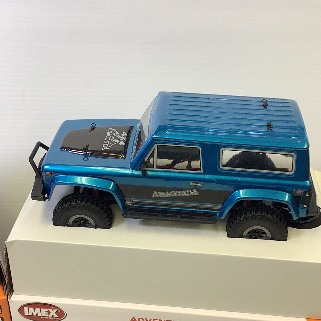 Blue scale model crawler vehicle with off-road tires for IMX IMX25005