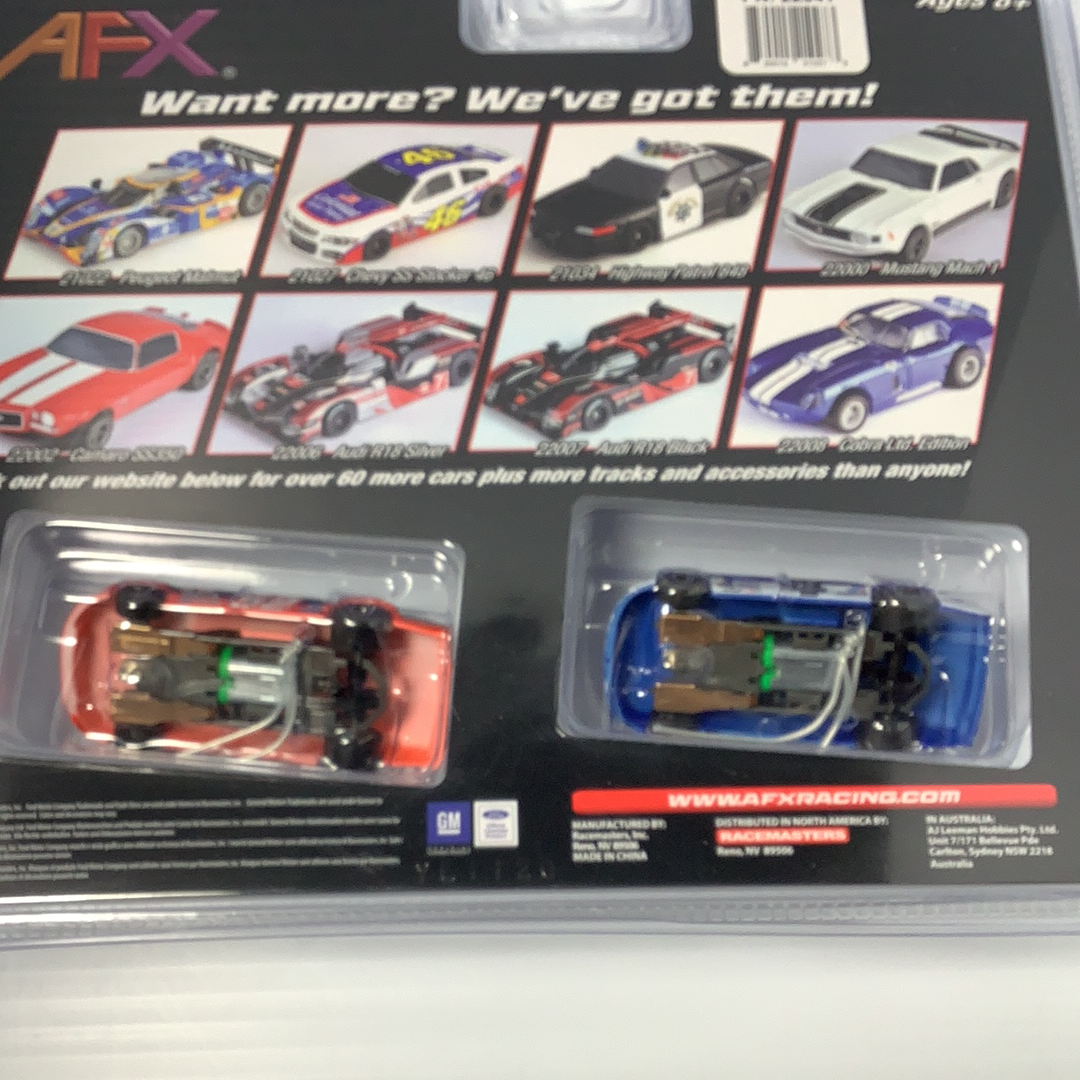Two slot car race cars in clear blister packaging for AFX/Racemasters 22041