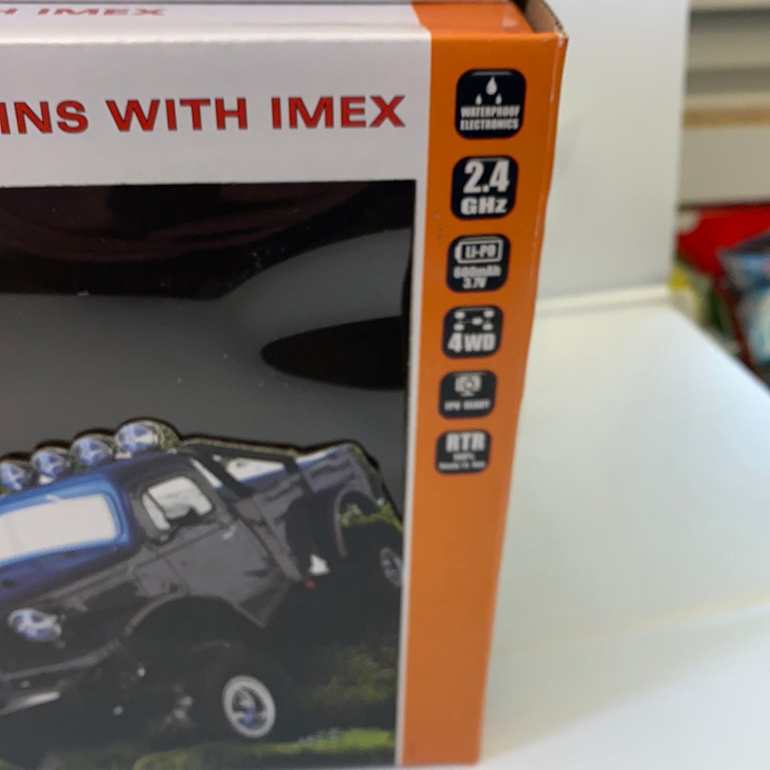 Remote-controlled crawler vehicle box showing features like 2.4GHz, 4WD, and waterproof rating for IMX IMX25010