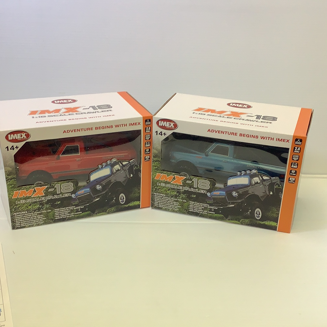 Two toy crawler vehicle boxes showing scale models of off-road vehicles for IMX IMX25000