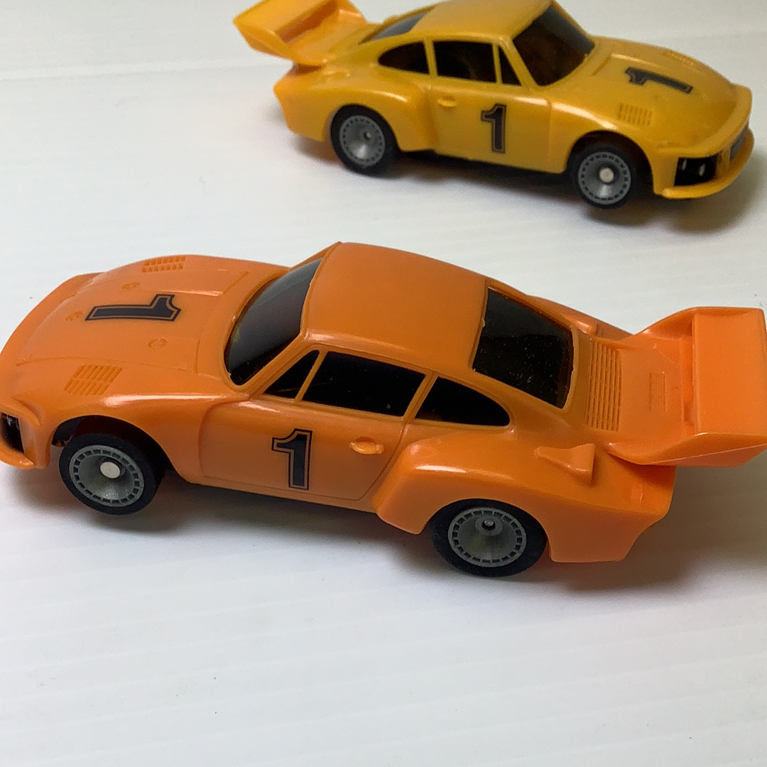 Orange Porsche model car with black windows and number one decal for Bachmann BAC0002