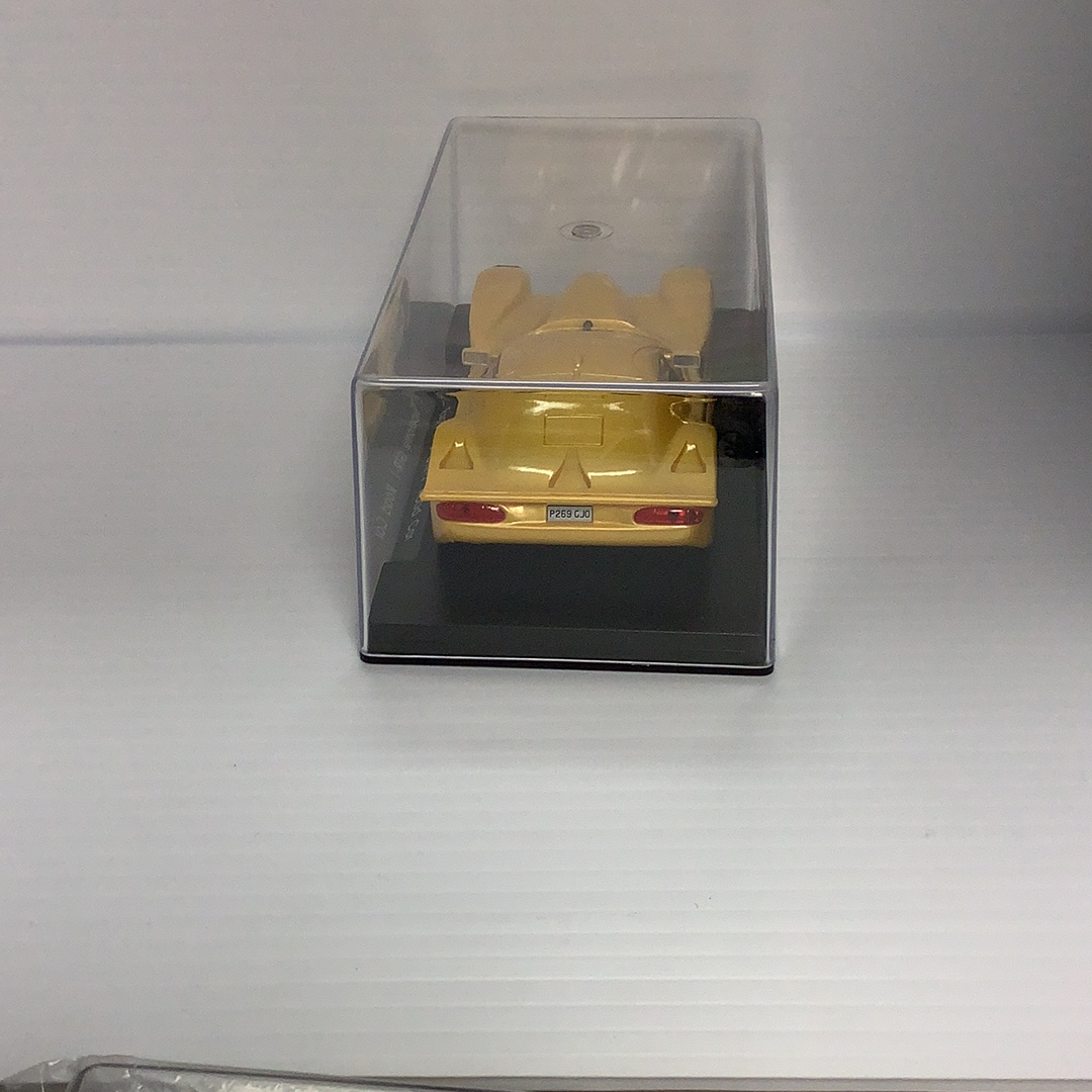 Yellow slot car in a clear display case for Fly Car A66, display case view, product view 3
