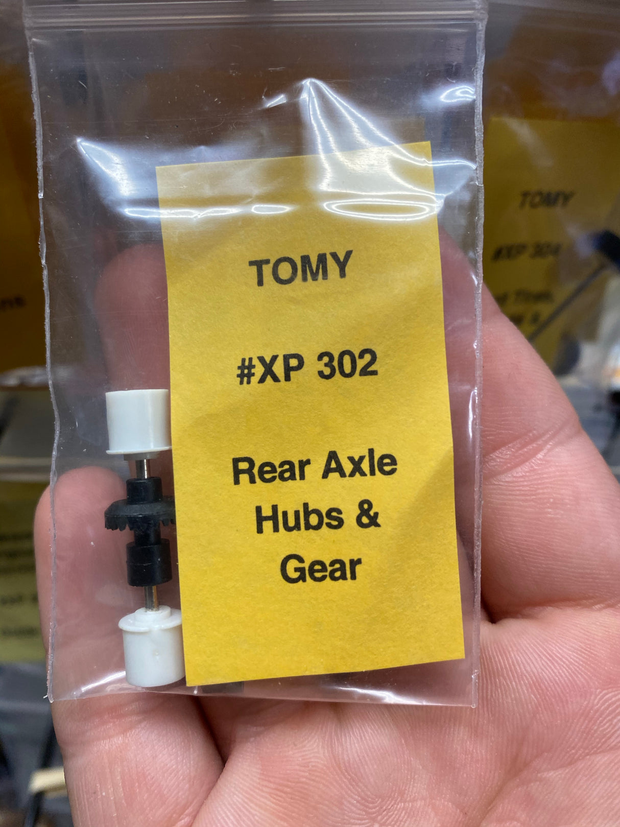 Tomy XP 302 rear axle hubs and gear parts in clear packaging