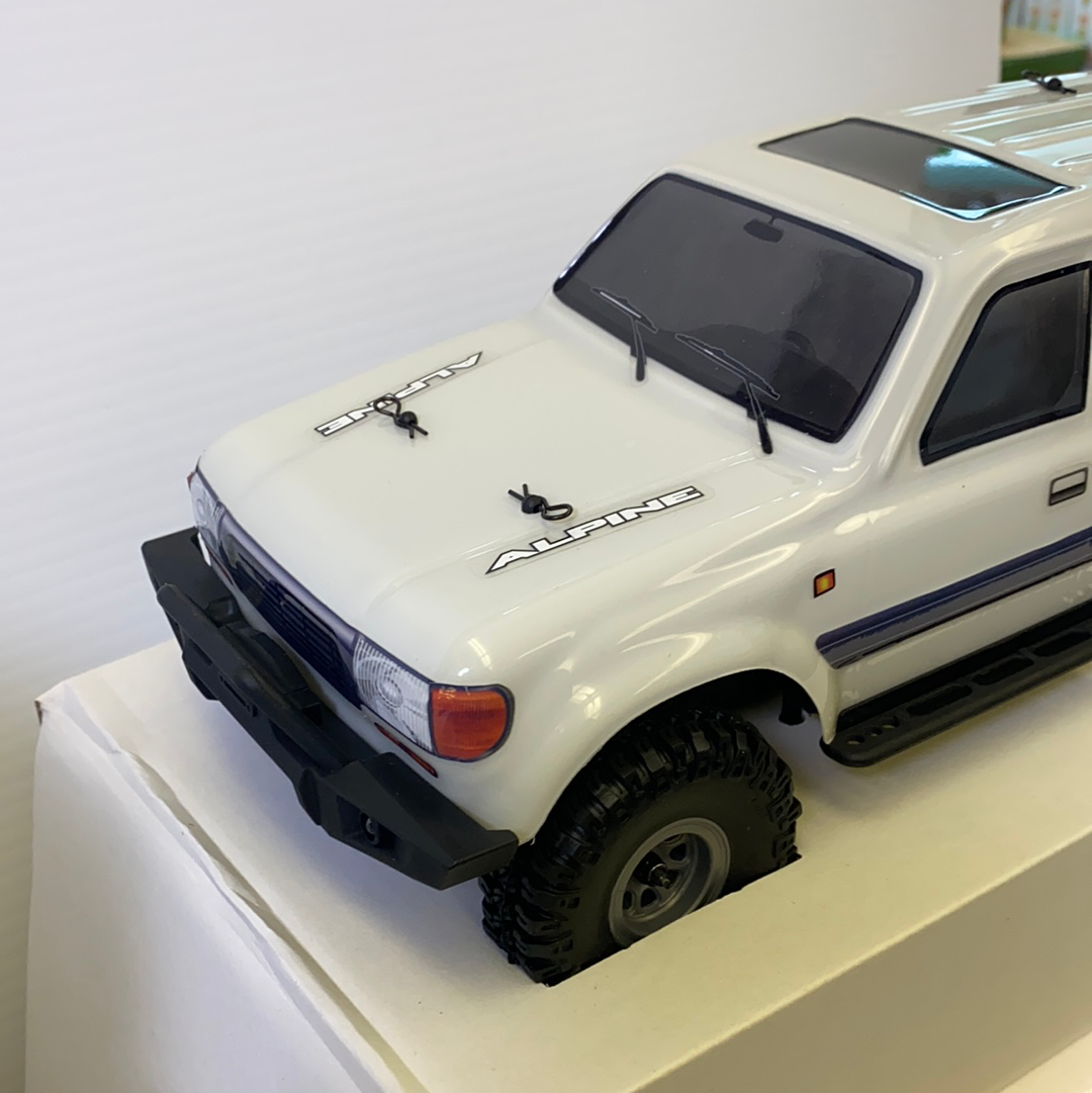 White scale model crawler with black trim and off-road tires for IMX IMX25020