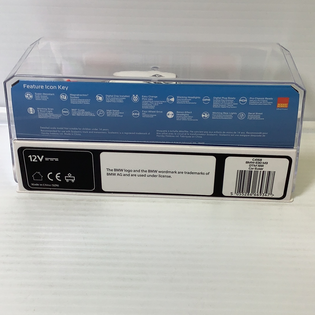 Product box showing feature icons for a BMW E30 M3 model car for Scalextric C4168