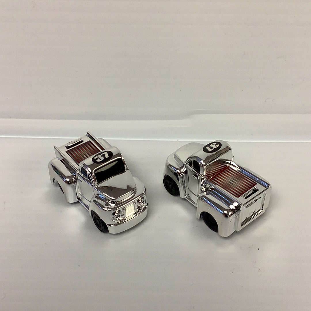 Two silver, chrome toy police cars with "37" marked on the front for California Creations 20552