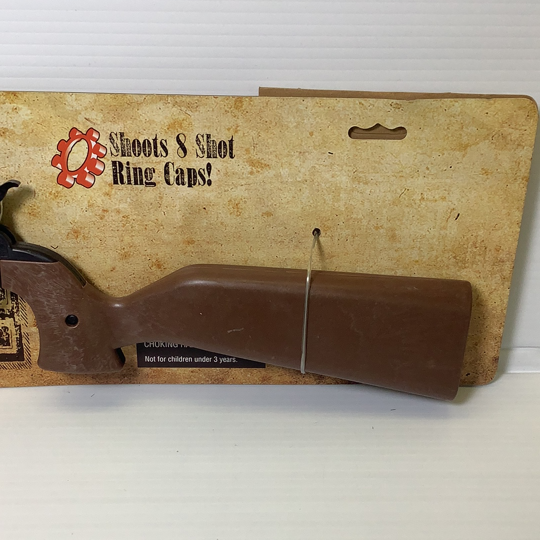 Toy rifle with brown stock resting on its cardboard box for Parris Toys 4731C