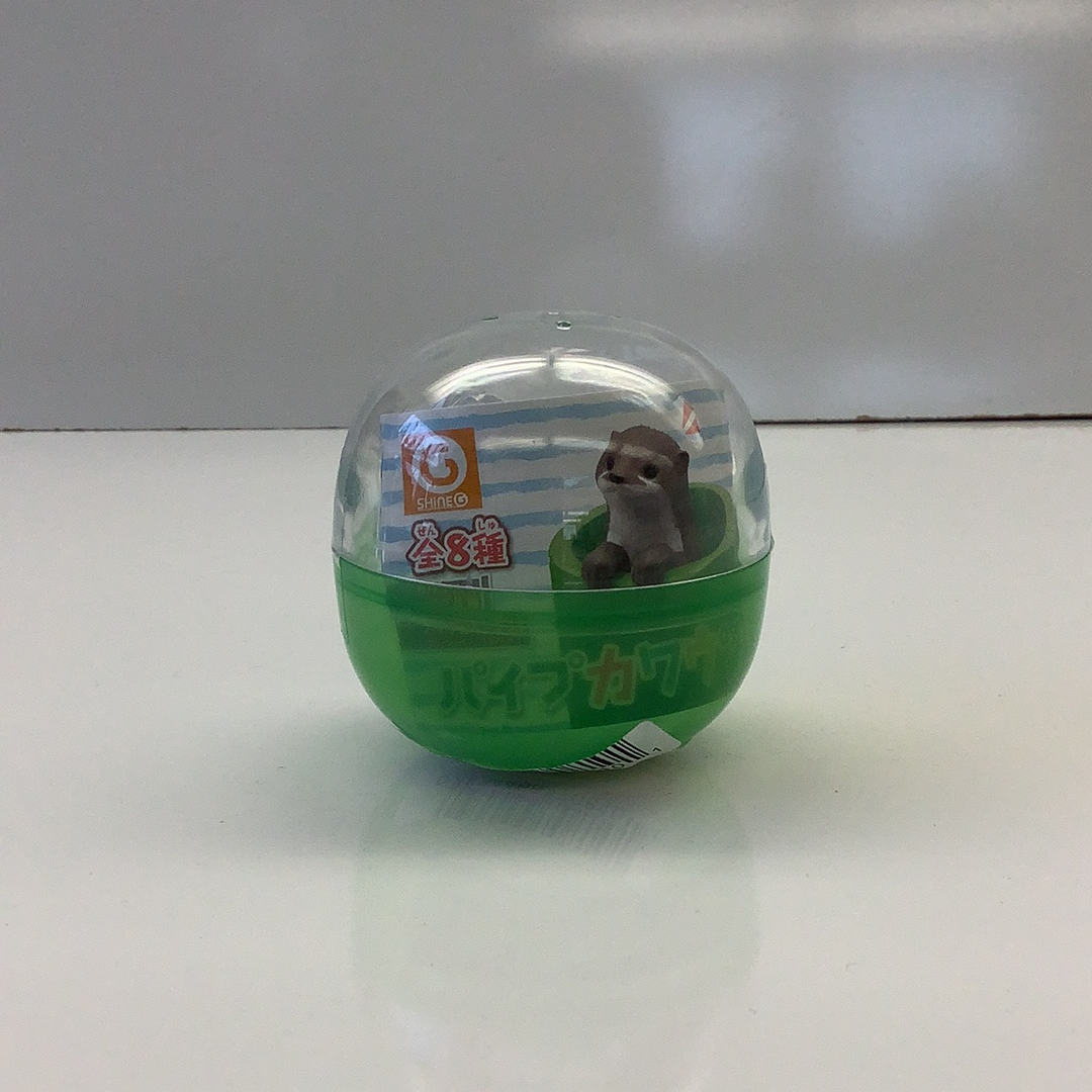 Small, clear capsule containing a brown otter figurine for BC USA 70810