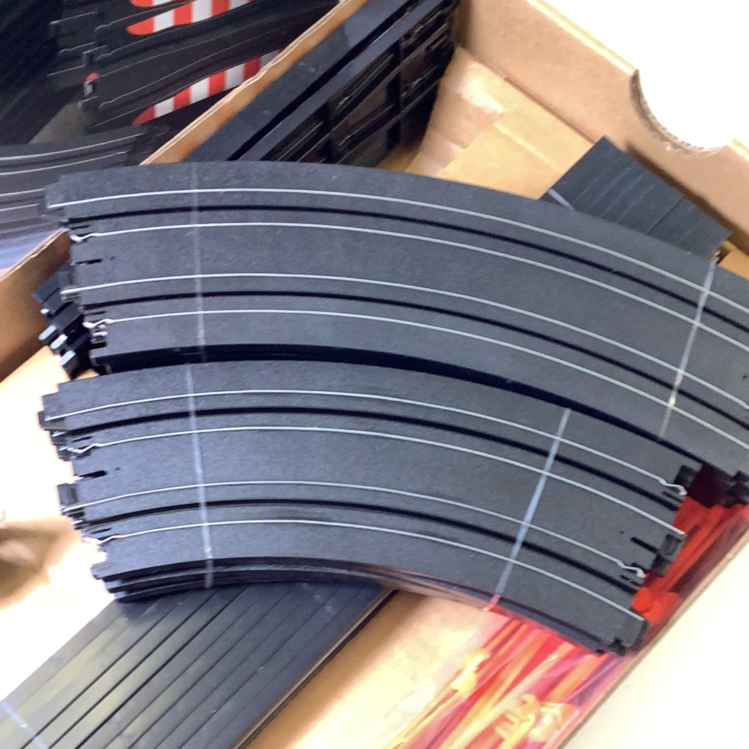 Curved black model train track pieces in a box for AFX/Racemaster 21045