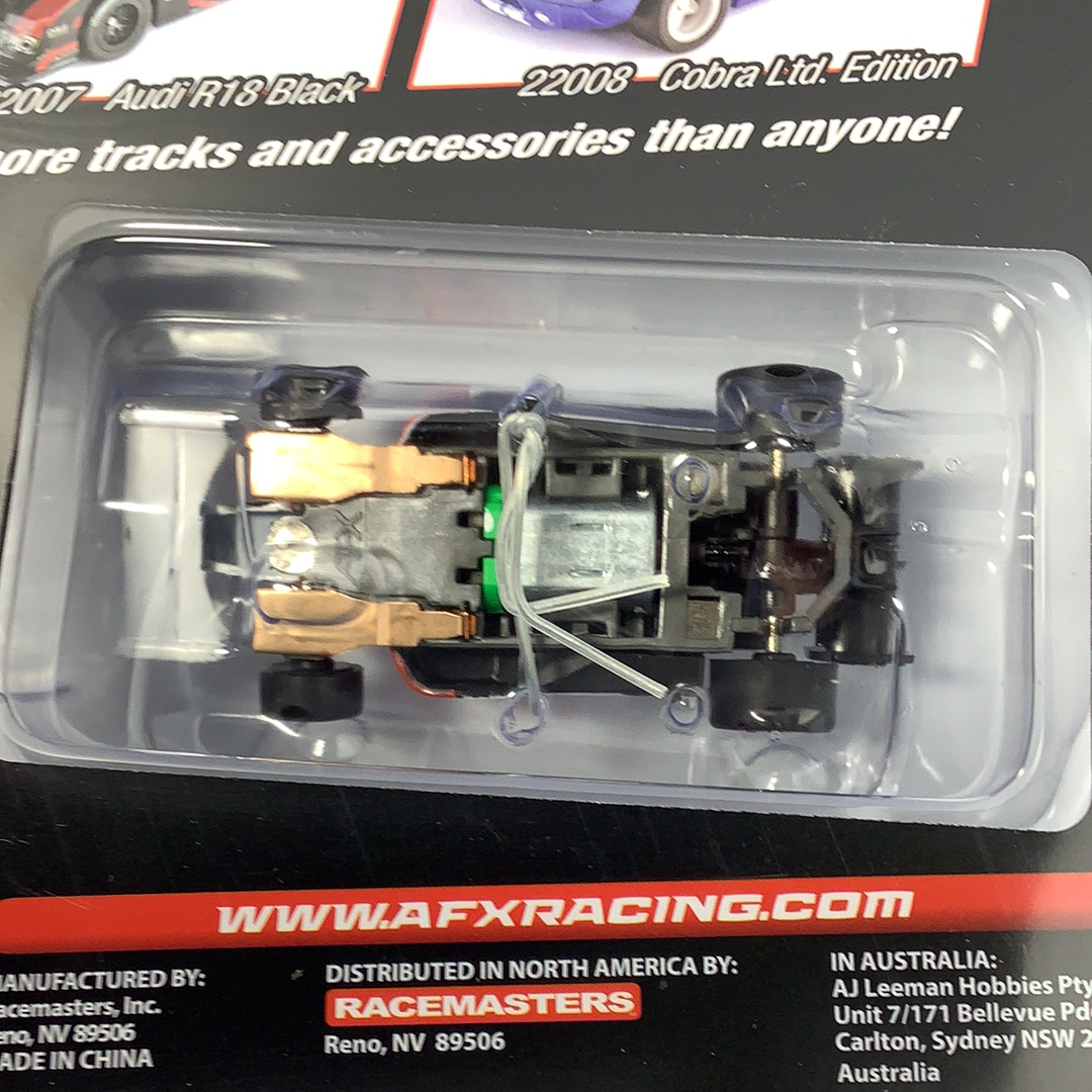 Black race car model in clear plastic packaging for AFX/Racemasters 22017