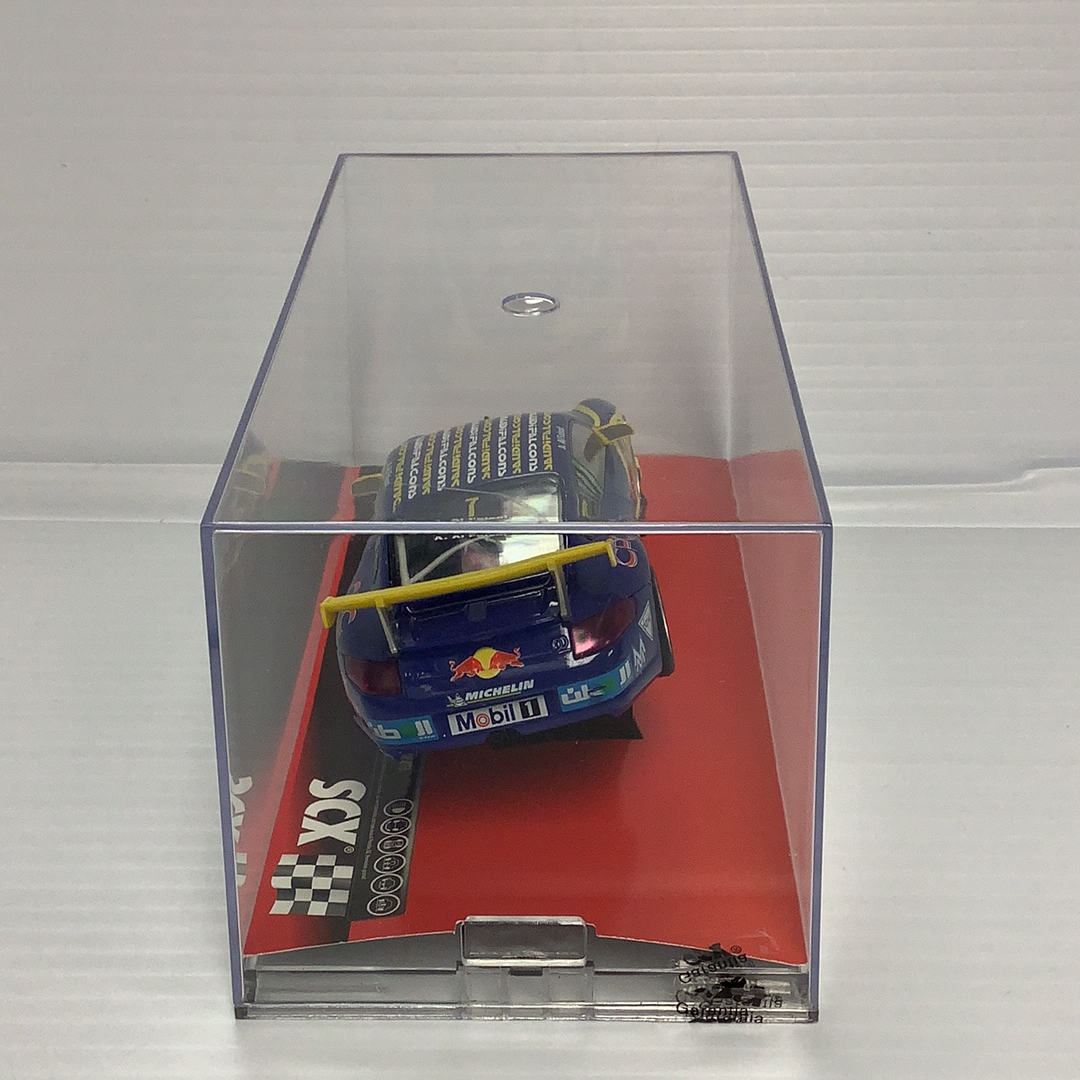 Slot car of a Porsche 911 GT3 Cup race car in a clear display box for SCX A10119X3U0