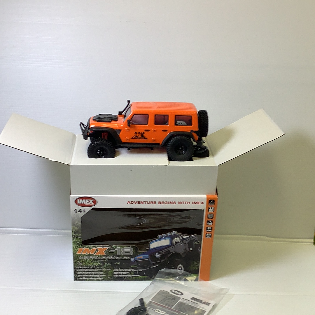 Orange and black scale crawler vehicle on its box for IMX IMX25015