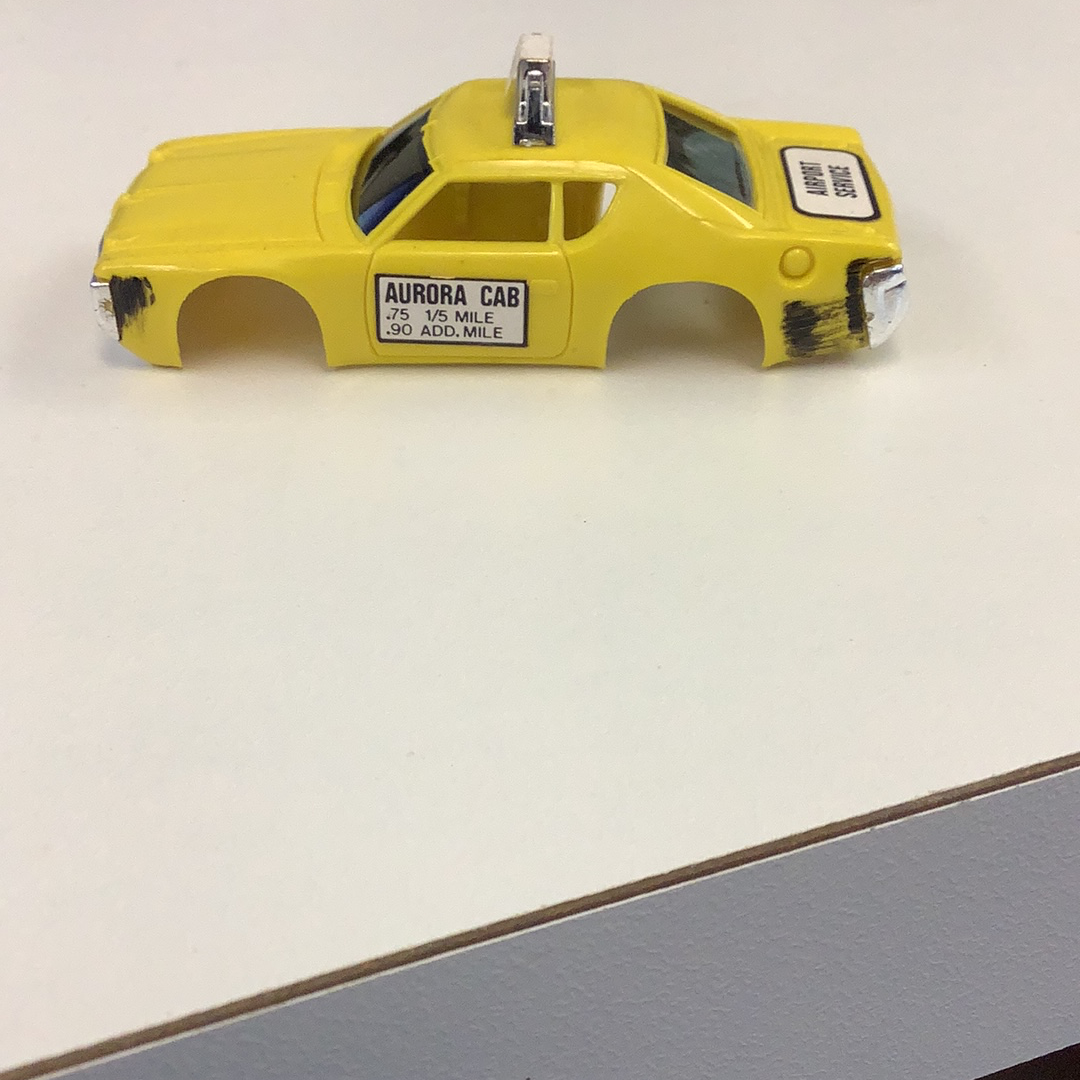 Yellow taxi body casting with "Aurora Cab" text on the side for Aurora / AFX / Tomy B1939Y
