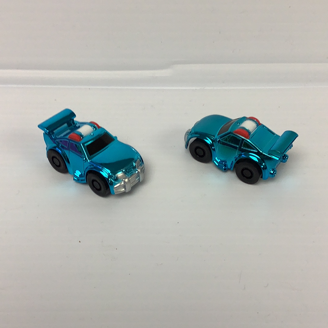 Two small, blue toy police cars on a white surface for California Creations 20720, rear view