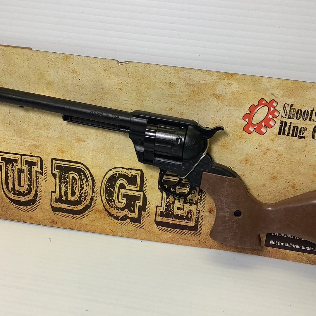 Toy rifle displayed on a cardboard box with "JUDGE" lettering for Parris Toys 4731C