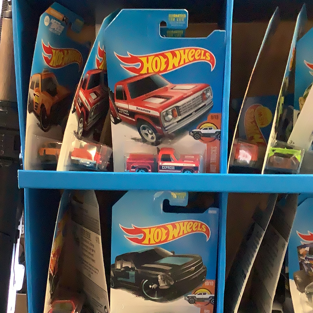 Assorted die-cast toy cars displayed on blue shelving for UPD FDY58-K910 l Assorted, front view