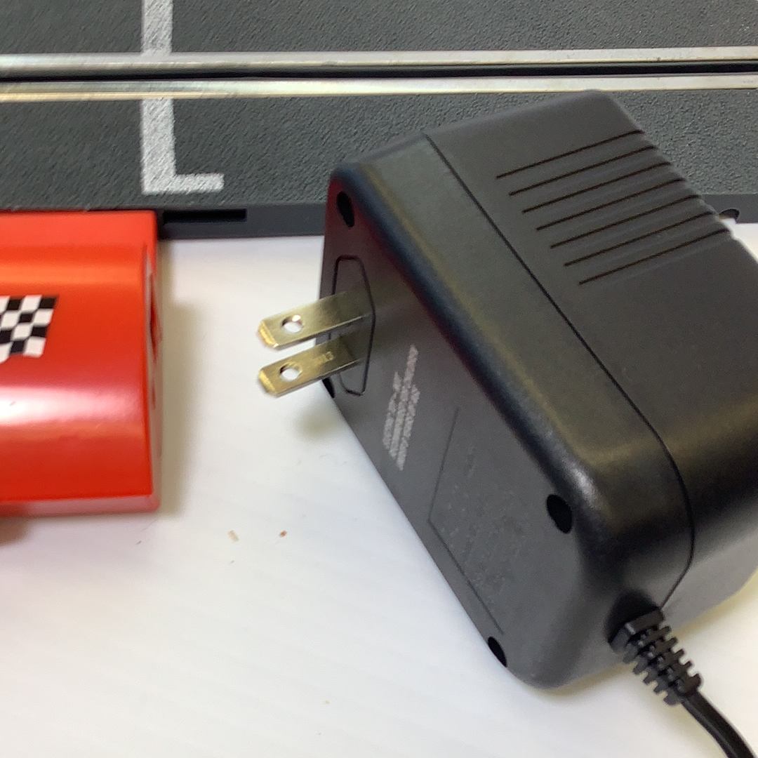 Black electronic unit with two metal terminals and attached black cord for SCX A4000