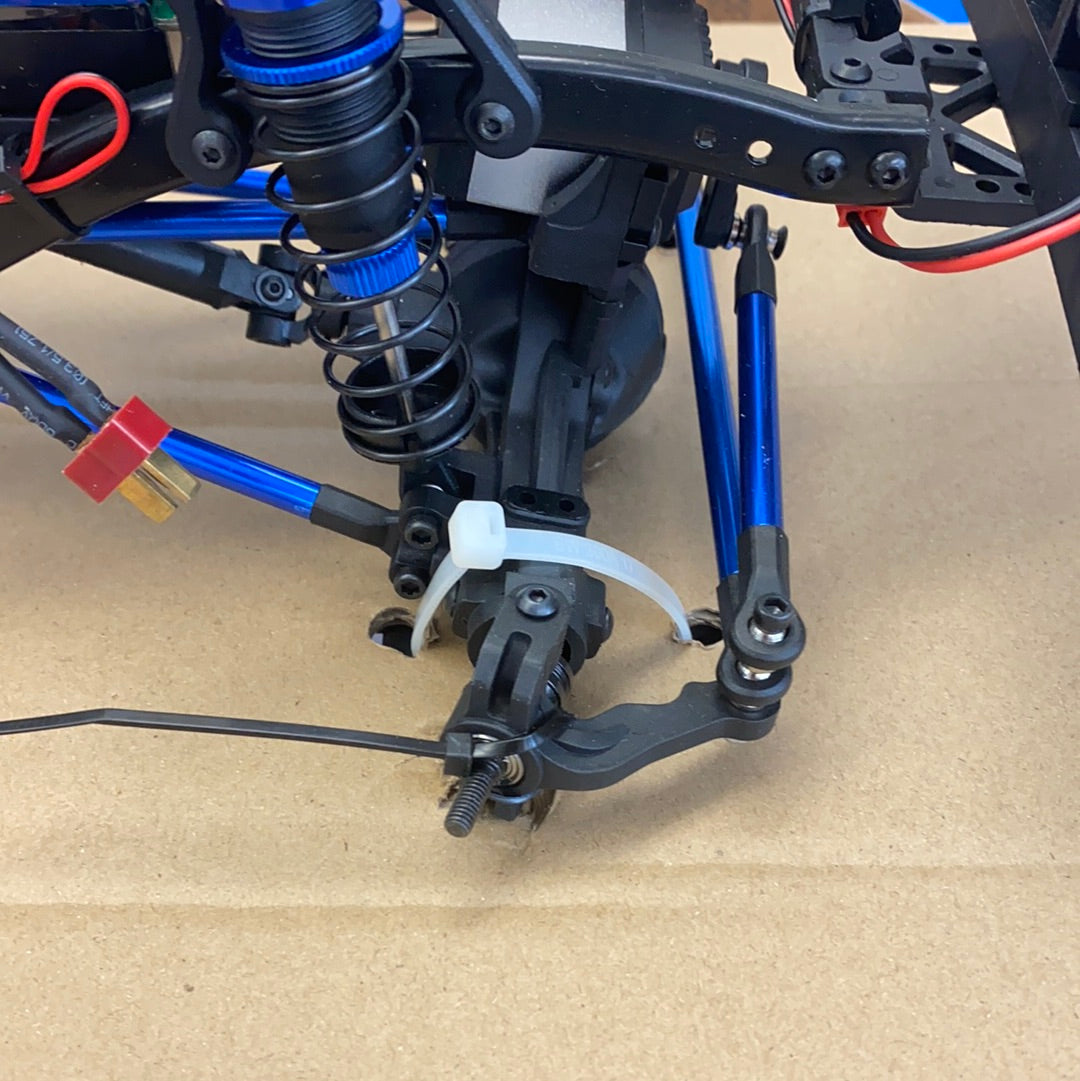 Crawler truck suspension components on brown cardboard surface for IMEX 22020