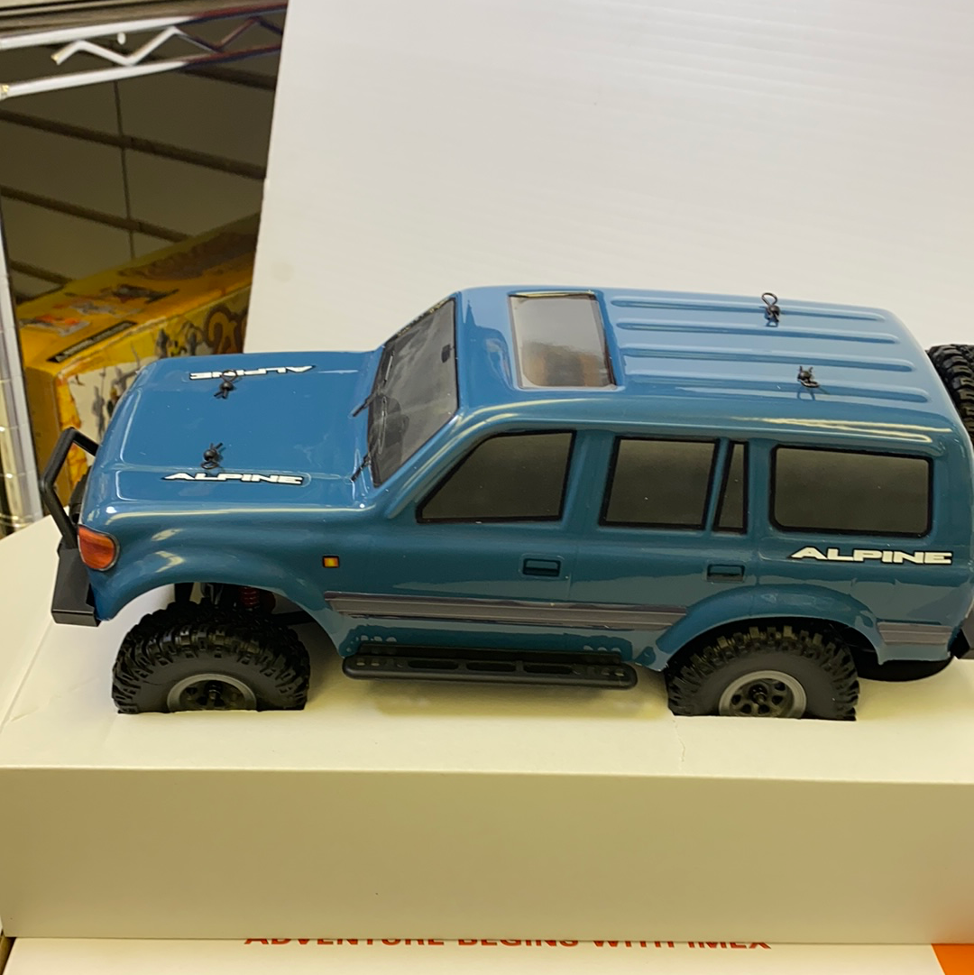 Blue scale model of an Alpine vehicle with off-road tires for IMX IMX25020