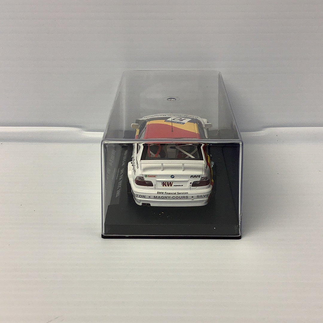 Slot car of a white BMW race car in a clear display case for Fly Car 88090