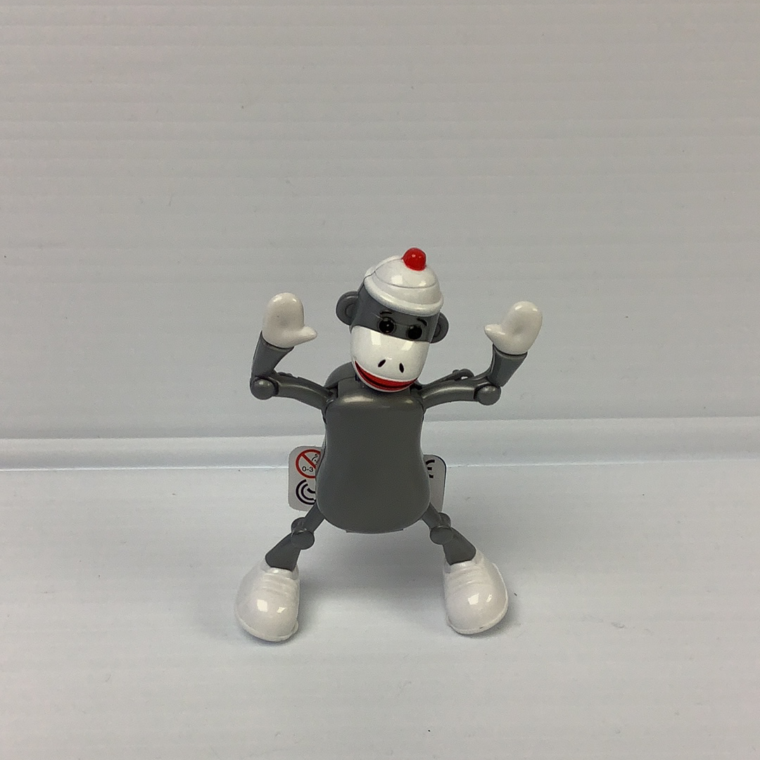 Sock monkey toy figure with arms raised, standing on a white surface for California Creations 75167, rear view
