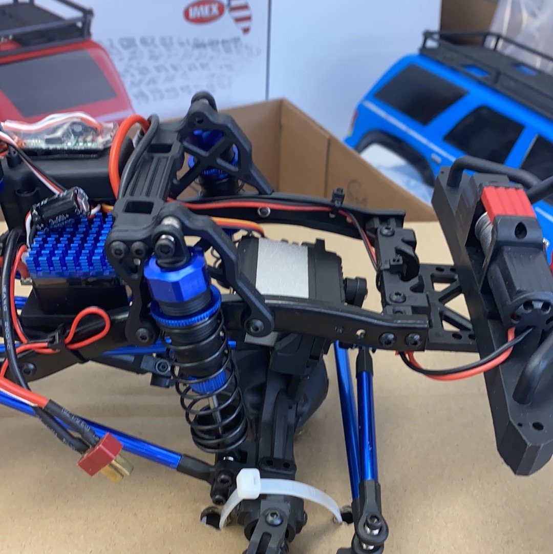 Crawler truck chassis with visible motors, suspension, and electronics components for IMEX 22025