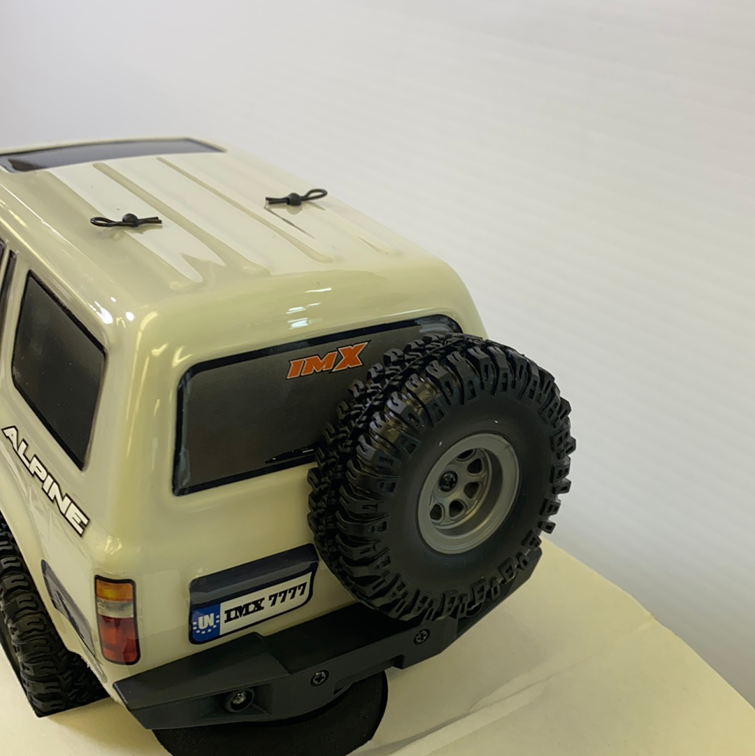 Scale crawler vehicle with off-road tires and "ALPINE" branding for IMX IMX25020