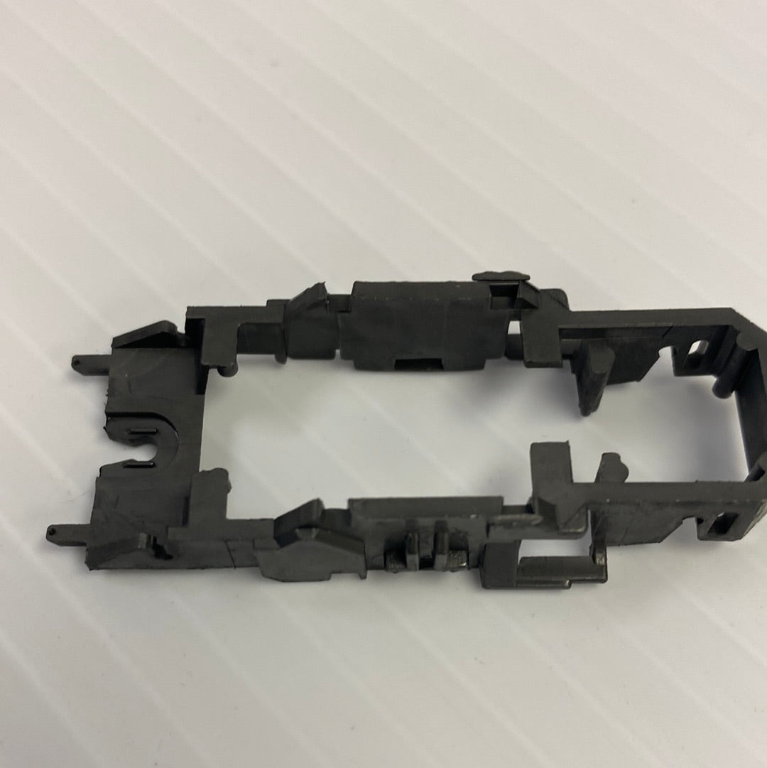Black chassis frame component for vehicle, showing mounting points for Tyco H4011