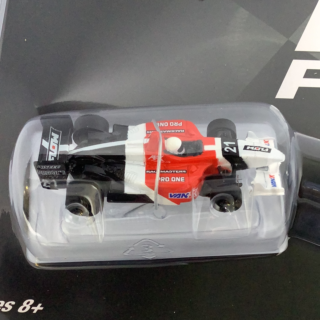 Red and white race car model in clear plastic packaging for AFX/Racemasters 22017