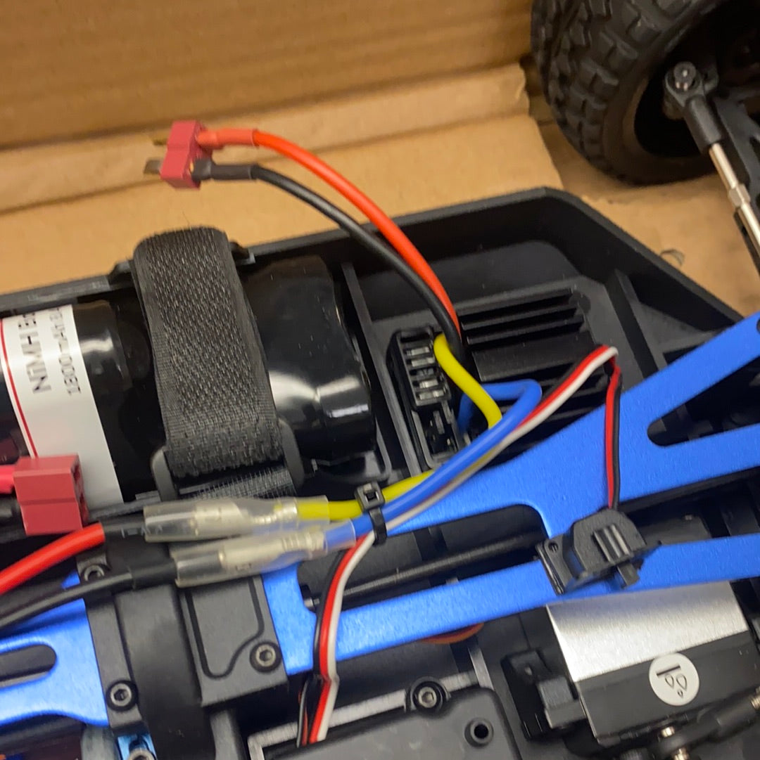 RC car electronics with battery, wires, and motor visible in a box for IMEX 22010