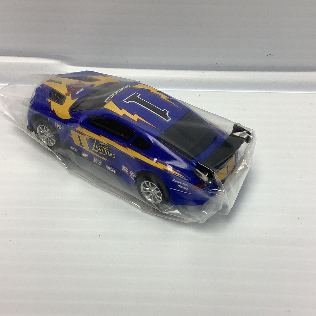 Blue race car model with yellow and black accents, labeled "Johnny Lightning." for Johnny Lighting JL2011