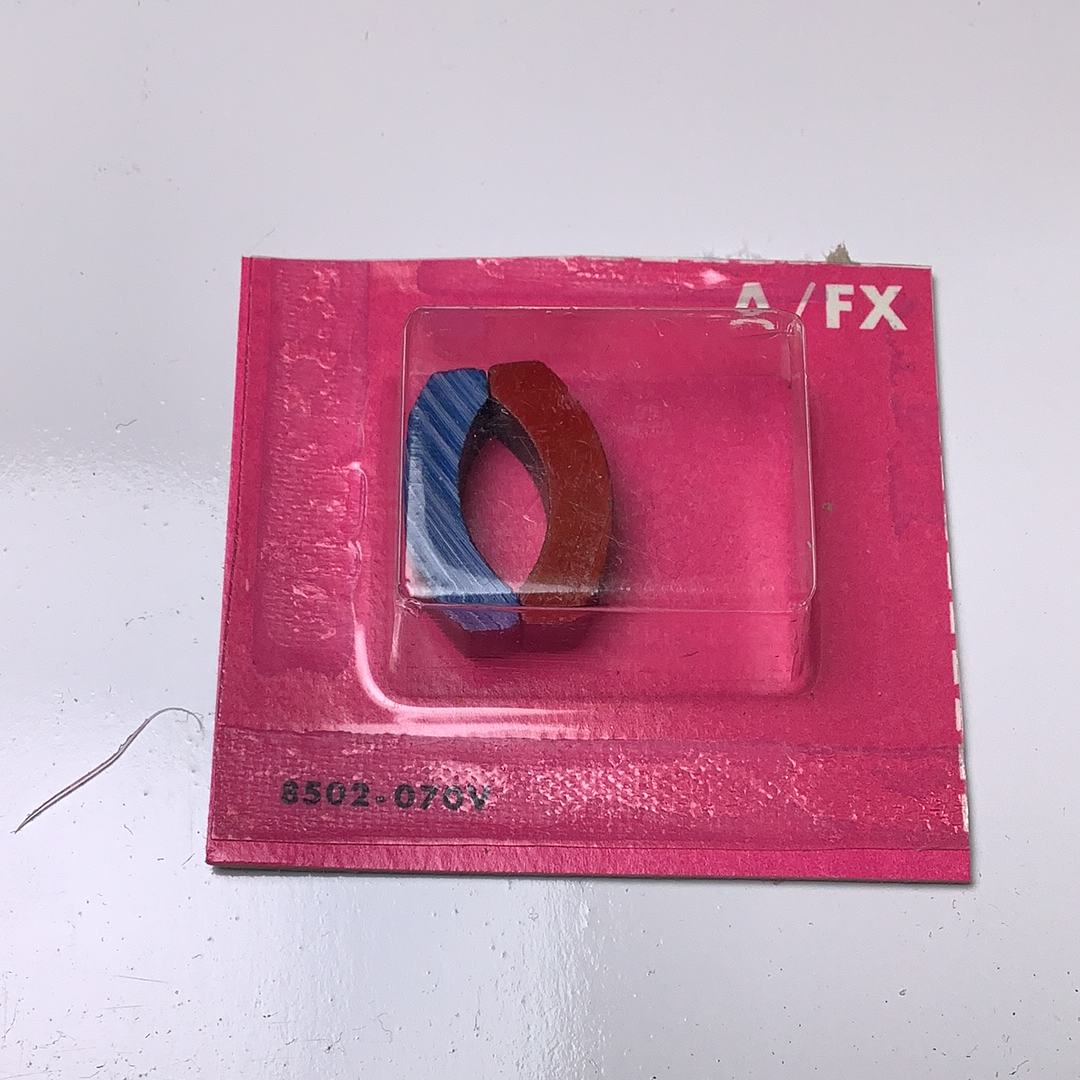 Two circular magnets in a pink plastic package for Aurora / AFX / Tomy 502