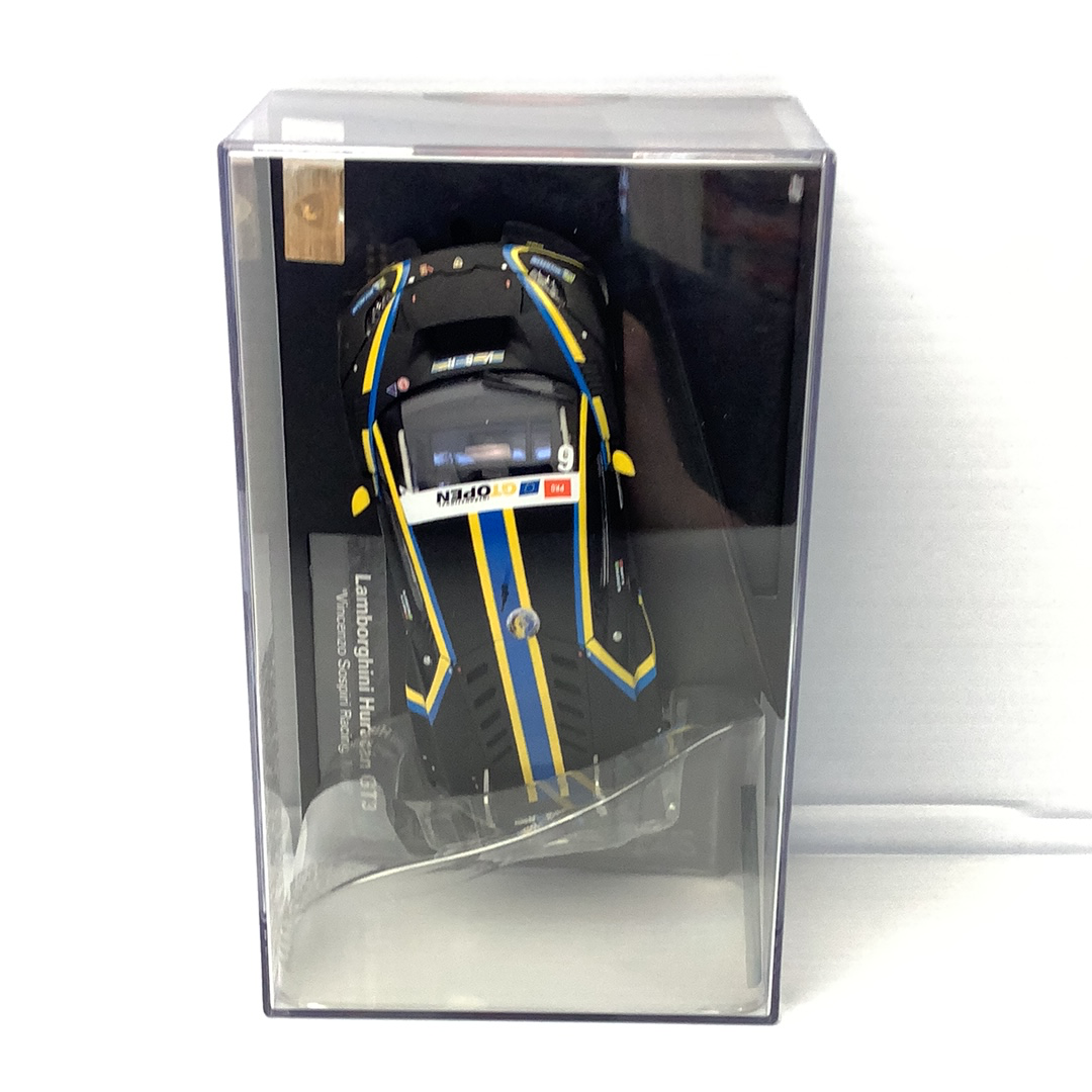 Slot car of a black and yellow Lamborghini Huracan GT3 race car in a clear box for Carrera 27595