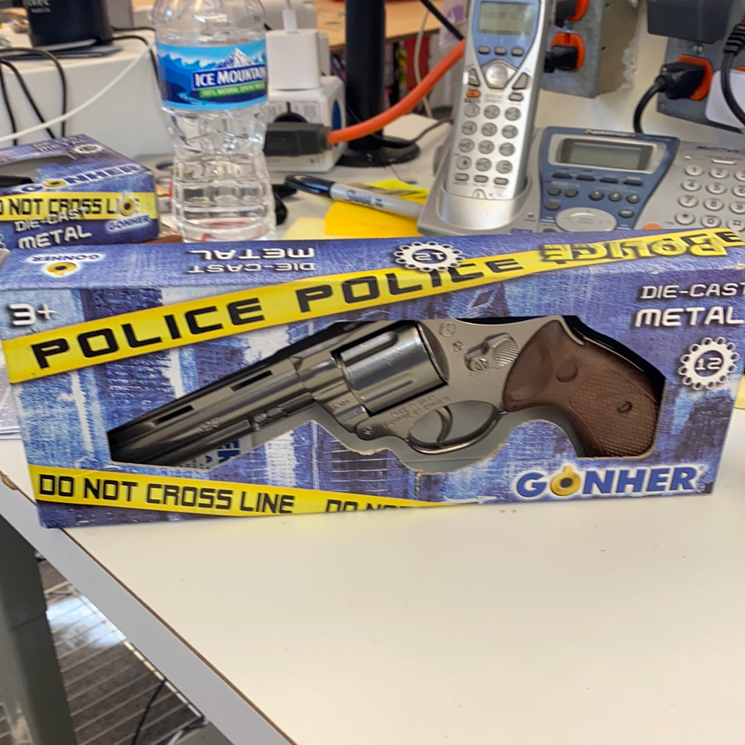 Die-cast police revolver toy with brown grip, displayed in a box for Gonher 123/0