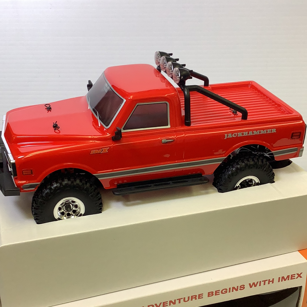 Red crawler truck with off-road tires and roof rack for IMX IMX25000