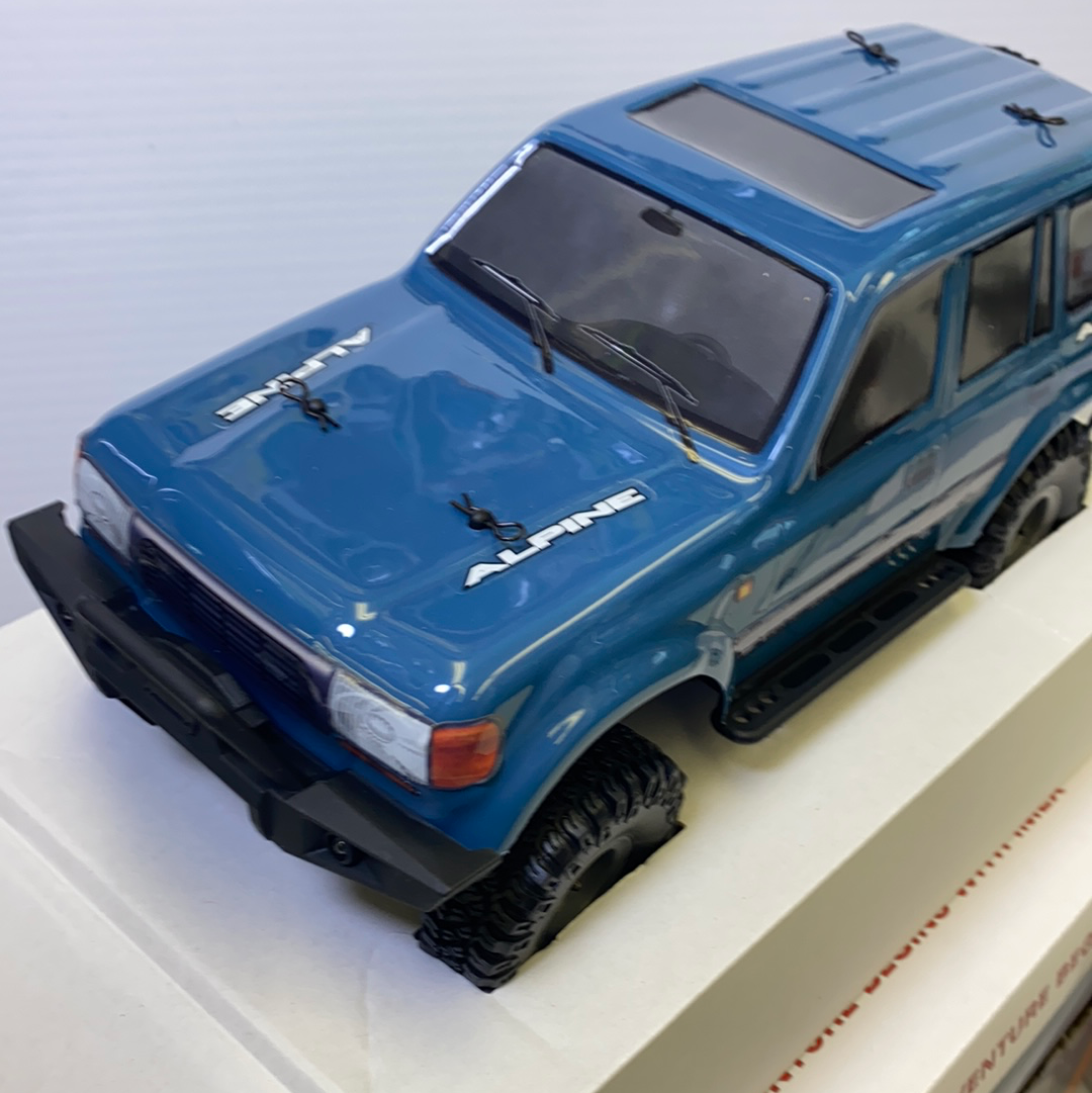 Blue scale model of an Alpine vehicle on a white surface for IMX IMX25020