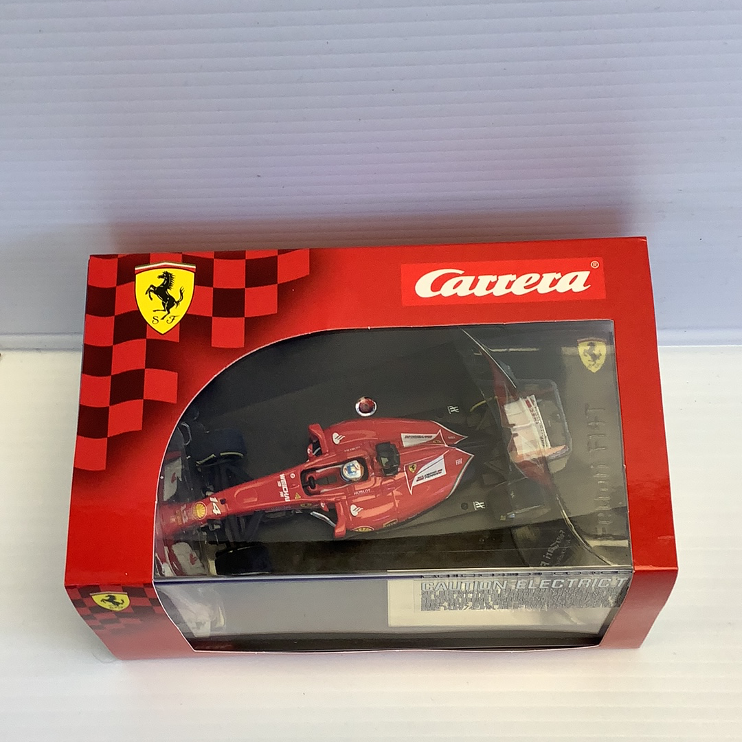 Red race car model in box, featuring Ferrari livery and checkered flag accents for Carrera Evolution 27496