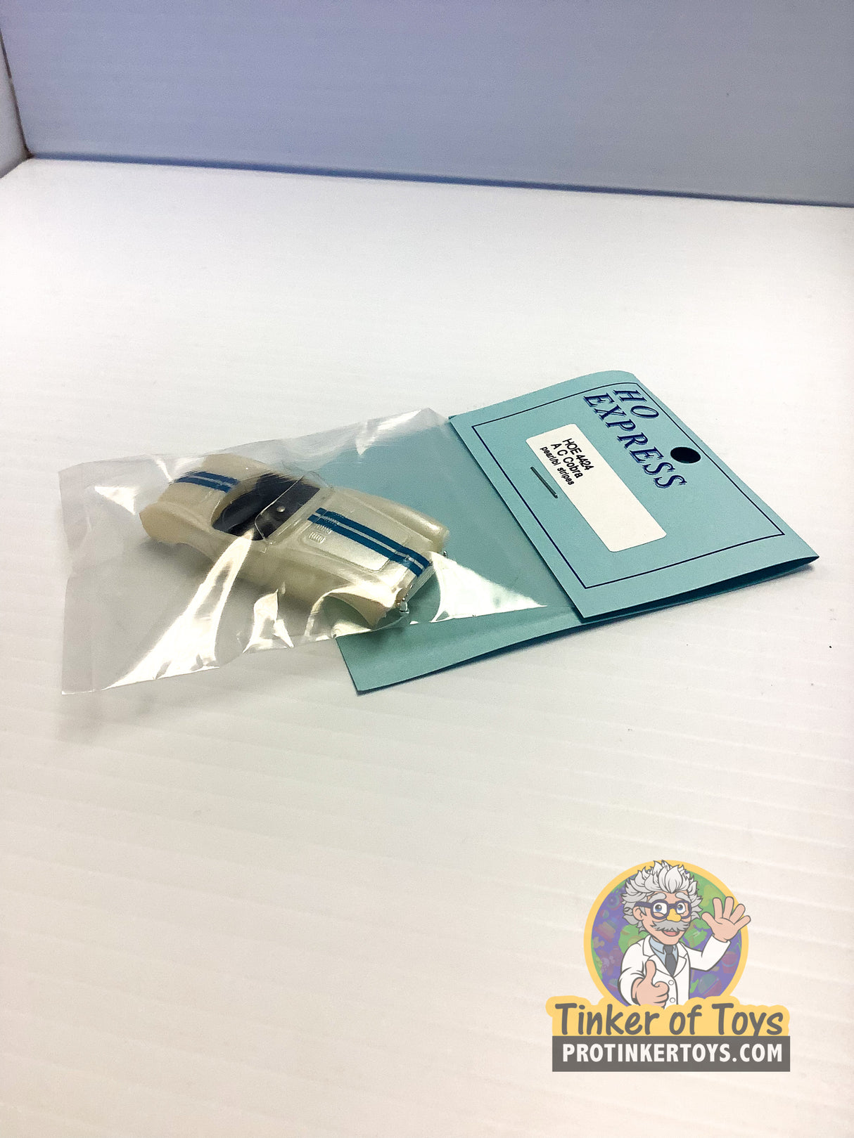 Die-cast AC Cobra model car in clear plastic packaging with HO Express card for 4424