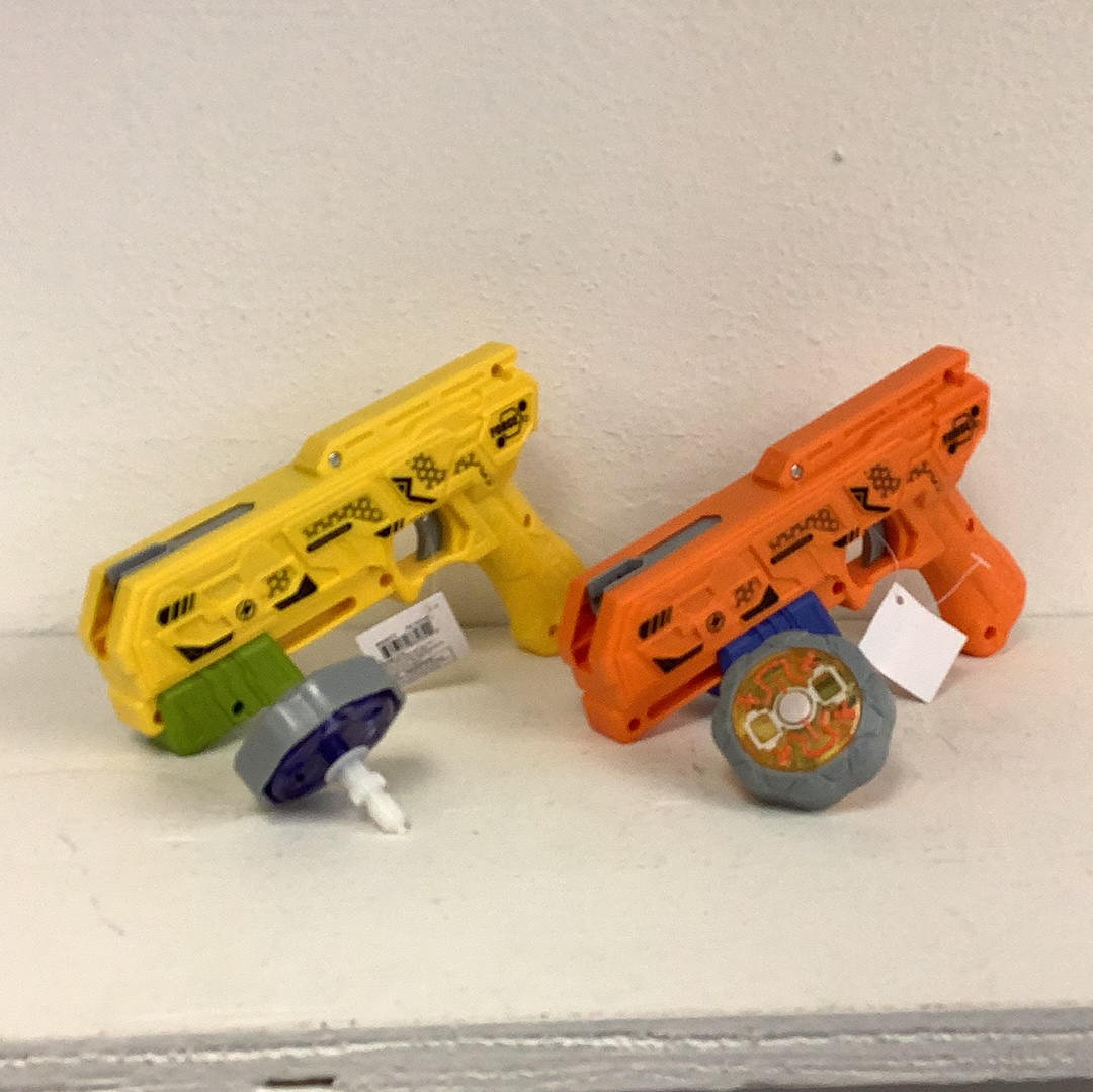 Yellow and orange spinning top blaster toy guns on a white surface for Schylling 88282TY