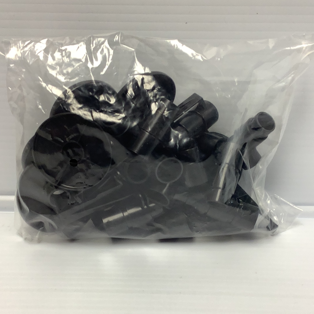 Assorted black plastic track support kit components in clear packaging for Johnny Lighting JL2006