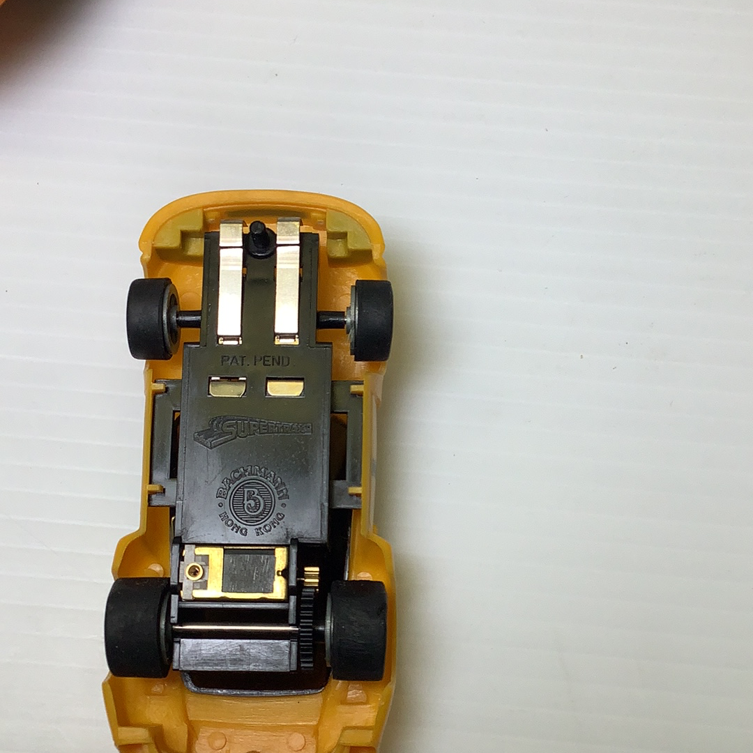 View of a slot car chassis showing the Supertrax suspension mechanism for Bachmann BAC0002